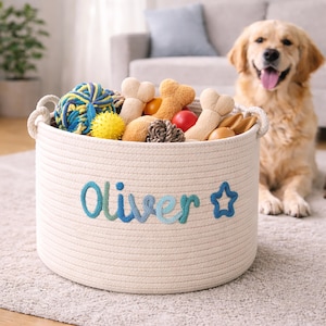 May include: A white ceramic mug with a black handle and the text "But first, coffee" in a black, handwritten-style font. The mug is on a white surface.