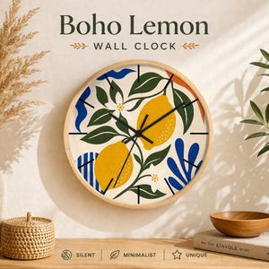 May include: A round wall clock with a light wood frame. The clock face features a lemon and leaf design in yellow, green, and blue. The text "Boho Lemon WALL CLOCK" is at the top. The clock is labeled "silent", "minimalist", and "unique".