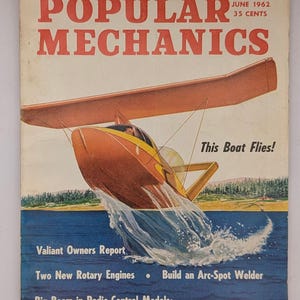 May include: A June 1962 issue of Popular Mechanics magazine featuring a cover illustration of a yellow and orange flying boat over blue water. The text reads How to Find the Best Air Conditioner, This Boat Flies, Valiant Owners Report, Two New Rotary Engines, Build an Arc-Spot Welder, and Big Boom in Radio-Control Models.