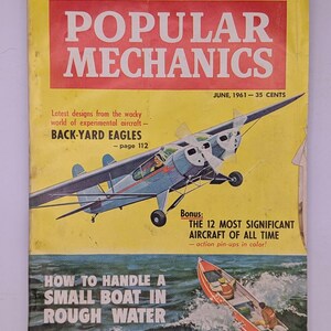 May include: Vintage June 1961 issue of Popular Mechanics magazine. The cover features a blue and white airplane illustration, a small boat on water, and text including "The Truth About Oil Changes" and "How to Handle a Small Boat in Rough Water."