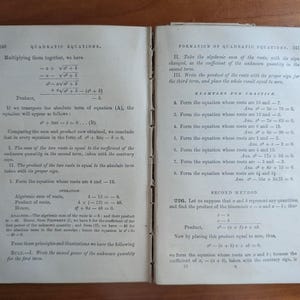 May include: Open book pages with text on quadratic equations. The left page has equations and formulas, while the right page lists examples for practice. The book is aged with a worn cover, suggesting it's an antique textbook.