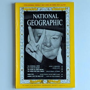 May include: A vintage August 1965 issue of National Geographic magazine. The cover features a black and white portrait of Winston Churchill making a peace sign. The magazine has a yellow border with text and floral designs.
