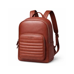 May include: A brown leather backpack with a padded front pocket and silver zips. The backpack features adjustable shoulder straps and a top handle. The brand name "AURUMEY LONDON" is visible on the front pocket.