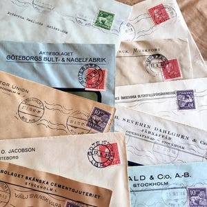 May include: A collection of vintage envelopes in various colors, including blue, tan, and cream. The envelopes feature stamps, postmarks, and handwritten text in Swedish. The stamps are in red, green, and purple. The envelopes are from different companies.