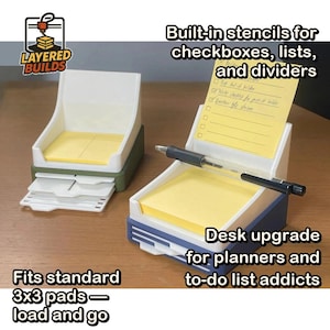 May include: Two desk organizers with white upper sections and colored bases, one olive green and one blue. Each holds a stack of yellow 3x3 sticky notes. The organizers feature built-in stencils for checkboxes, lists, and dividers, with a pen resting across the front.