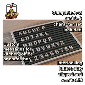 May include: A rectangular letter board with a light-colored frame and horizontal black grooves. The board displays white, three-dimensional letters A-Z and numbers 0-9. Text on the image includes: Complete A-Z and 0-9 character set included, Custom messages for kitchen, office or coffee bar, and Interlocking letters stay aligned and won't shift.