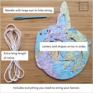May include: A set of colourful paper shapes with a map design, a needle with a large eye, and a long length of twine. The shapes are labelled with letters and arrive in order. The text "Letters and shapes arrive in order." is included in the image.