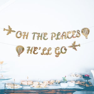 May include: A gold banner with the text "Oh the places he'll go" in a vintage map font. The banner is decorated with paper airplanes and hot air balloons.