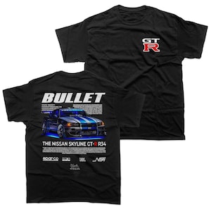 May include: Black t-shirts featuring a car graphic with the text "BULLET" and "THE NISSAN SKYLINE GT-R R34". One shirt has a red "GT-R" logo. The graphic includes the Sparco, HKS, JBL, and NOPI logos.
