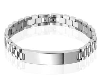 May include: A silver bracelet with a rectangular, blank tag. The bracelet has a link chain design.