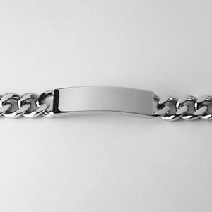 May include: A silver chain bracelet with a blank rectangular tag. The chain is a curb style.