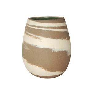 May include: A brown ceramic vase with white swirling stripes. The vase has a green glazed rim.