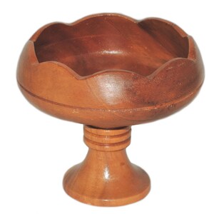 May include: A wooden bowl with a scalloped edge sits on a pedestal base. The bowl is made of light brown wood and has a smooth finish.