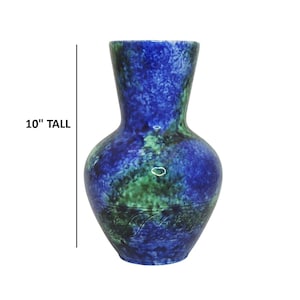 May include: A 10-inch tall vase with a blue and green marbled design. The vase has a wide base, a narrow neck, and a decorative etched pattern near the base. The color palette includes shades of blue and green.