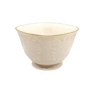 May include: A white porcelain bowl with a gold rim and intricate embossed design. The bowl has a square shape and a rounded bottom.