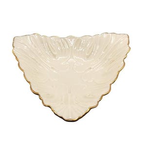 May include: Cream-colored, triangular decorative dish with a scalloped edge and gold trim. The dish has a textured, leaf-like pattern on the interior. A decorative piece for serving or display.