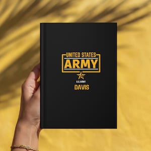 May include: A black hardcover notebook featuring the yellow text UNITED STATES ARMY enclosed in a rectangular frame, a yellow star, the text U.S. ARMY, and the name DAVIS printed in yellow capital letters on the front cover.