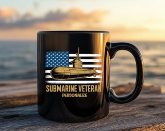May include: A black ceramic mug featuring a graphic of a submarine superimposed over a stylized American flag. Below the submarine, the text reads SUBMARINE VETERAN and PERSONALIZE in gold lettering. The mug has a curved handle and a glossy finish.