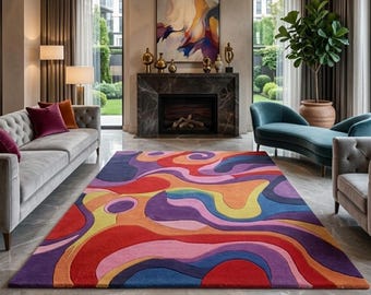 May include: A rectangular area rug featuring a vibrant, multi-colored abstract pattern with flowing, wavy shapes in shades of red, orange, yellow, pink, purple, and blue. The rug has a textured, tufted appearance and covers a polished stone floor.