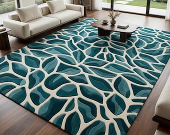 May include: A large rectangular area rug featuring a repeating organic pattern of teal and blue leaf-like shapes separated by a cream-colored background. The design creates a textured, layered effect across the surface of the floor covering.