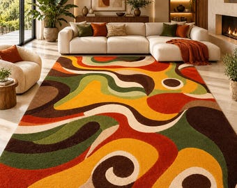 May include: A large rectangular area rug featuring a bold, abstract pattern of flowing, organic shapes in vibrant shades of orange, mustard yellow, deep forest green, dark brown, and cream, covering the floor in a living room space.