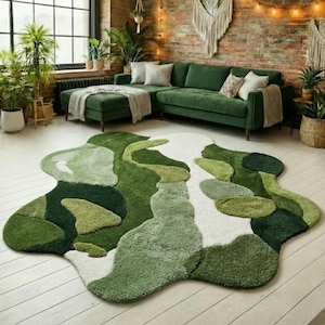May include: A contemporary living room with a green corner sofa, ottoman, and a distinctive, abstract rug. The rug displays a pattern of diverse shades of green and white, introducing a nature-inspired design element to the room.