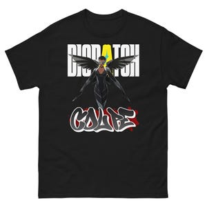 May include: Black t-shirt featuring a graphic of a woman with angel wings, the word "DISPATCH" above her, and the word "CALIPE" in graffiti style below. The design includes yellow and red accents.