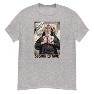 May include: A gray t-shirt featuring a graphic of a nun with blood on her face and hands, holding a cross. Text on the shirt reads "The Florida Battalion done it" and "Second to Nun!"