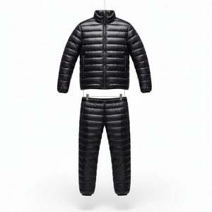 May include: A black, quilted down jacket and matching pants set. The jacket has a stand-up collar and a full-length zipper. The pants have an elastic waistband. Both pieces are made of a shiny, lightweight material, perfect for outdoor activities.