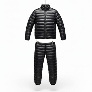 May include: A black, quilted down jacket and matching pants set. The jacket has a stand-up collar and a full-length zipper. The pants have an elastic waistband. Both pieces are made of a shiny, lightweight material, perfect for outdoor activities.