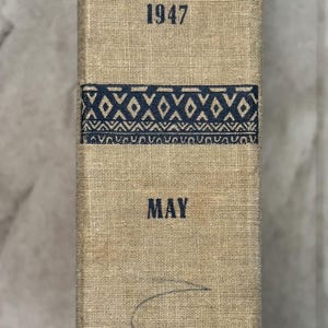May include: A vintage book titled "A Century of Silver" with the years 1847-1947. The cover is beige with blue text and decorative patterns. The publisher's name, McBride, is at the bottom.