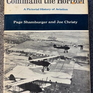 May include: Vintage book cover titled "Command the Horizon: A Pictorial History of Aviation" featuring a black and white image of biplanes flying over a landscape. The cover also displays the authors' names.