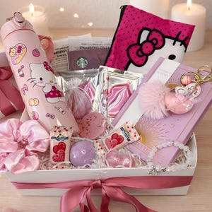 May include: A pink gift basket filled with Hello Kitty themed items. Includes a pink water bottle, a pink pouch, a planner, bath bombs, sweets, and a bracelet. The basket is tied with a pink ribbon and surrounded by candles.