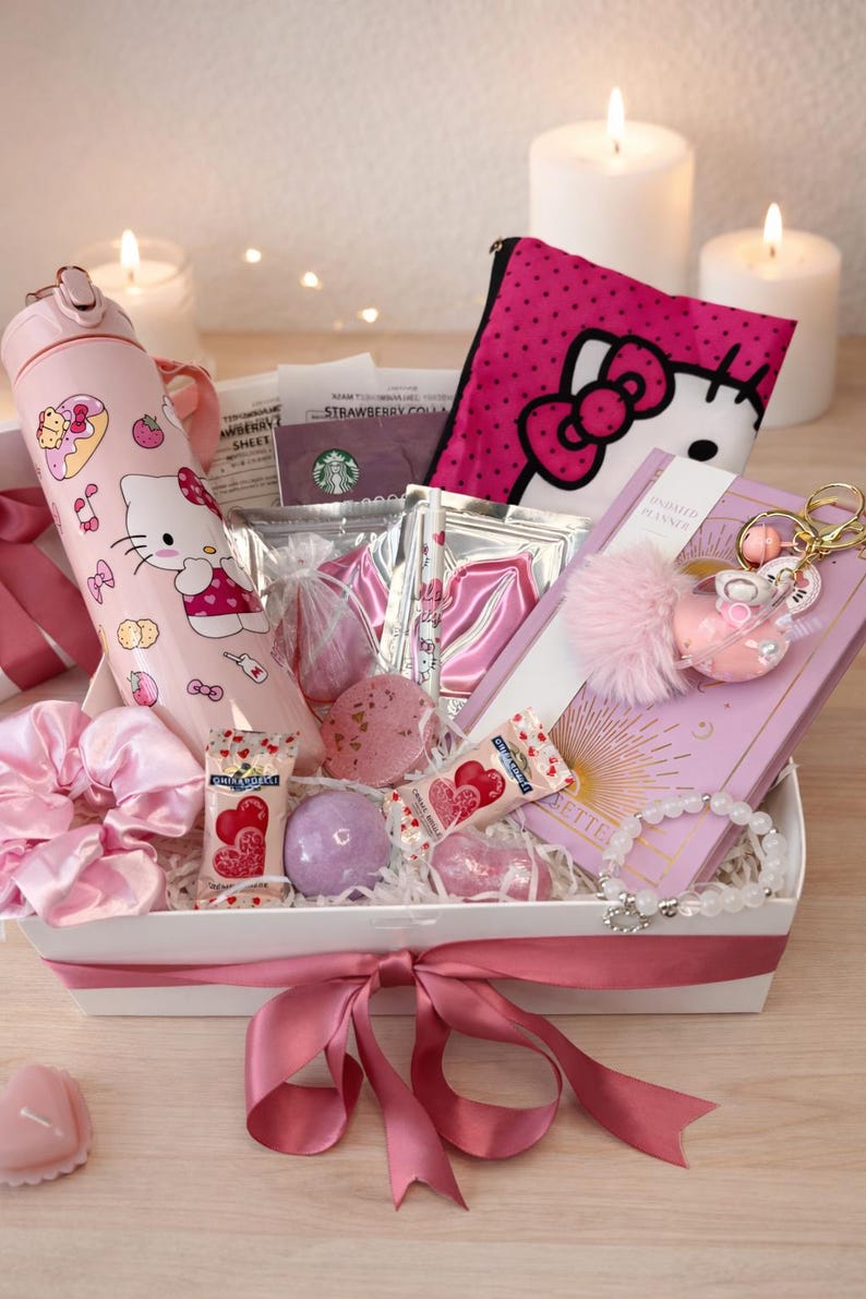 May include: A pink gift basket filled with Hello Kitty themed items. Includes a pink water bottle, a pink pouch, a planner, bath bombs, sweets, and a bracelet. The basket is tied with a pink ribbon and surrounded by candles.