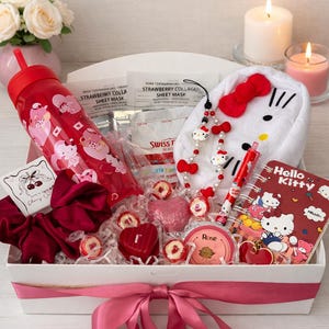 May include: A gift box featuring Hello Kitty merchandise. It contains a red tumbler, a Hello Kitty plush, a notebook, a pen, a necklace, and heart-shaped sweets. The box is tied with a pink ribbon and includes sheet masks.