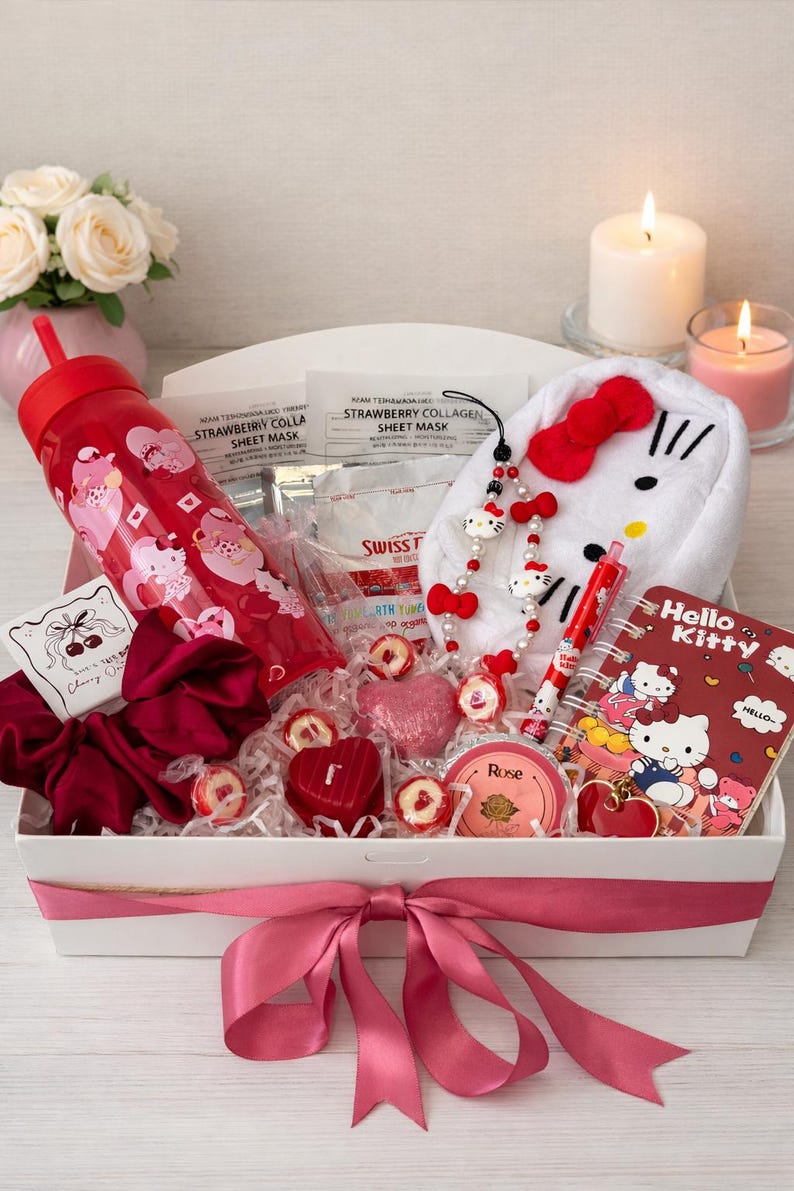 May include: A gift box featuring Hello Kitty merchandise. It contains a red tumbler, a Hello Kitty plush, a notebook, a pen, a necklace, and heart-shaped sweets. The box is tied with a pink ribbon and includes sheet masks.