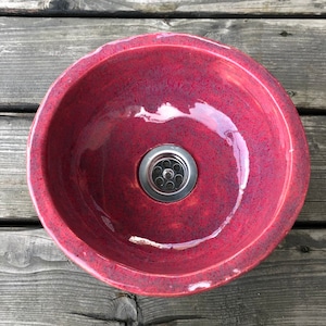 a small raspberry, ceramic basin -