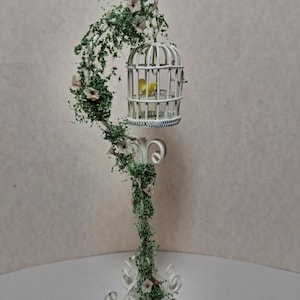 Miniature dollhouse birdcage with bird and flowers