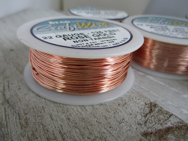 Pu&ograve; includere: Un rotolo di filo artigianale in oro rosa da 22 gauge, lungo 128 piedi. Il filo &egrave; anti-appannamento ed &egrave; realizzato negli Stati Uniti. L'etichetta recita "Craft Wire - 128 Feet Gauge - 22 Rose Gold Non Tarnish Not a toy -  Int. Use for Adult Use Only - Made in the USA www.beadsmith.com"