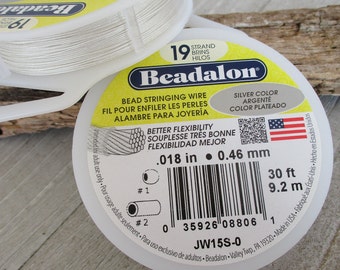 May include: Two spools of Beadalon bead stringing wire. The label indicates silver color, 0.018 inch diameter, and 30 feet of wire. The packaging is white with yellow and blue text.