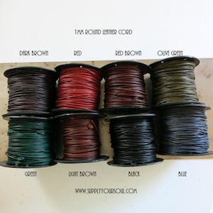 May include: Eight spools of 1 mm round leather cord in a variety of colours, including dark brown, red, red brown, olive green, green, light brown, black, and blue. The spools are arranged in two rows of four. The text "1MM ROUND LEATHER CORD" is printed above the spools. The text "WWW.SUPPLYYOURSOUL.COM" is printed below the spools.