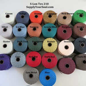 May include: A collection of 20 spools of S-Lon Tex 210 cord in various colors, including cream, indigo, orange, copper, brown, green, silver, ice blue, nutmeg, green/blue, burgundy, oyster, dark teal, evergreen, bronze, seashell, black, purple, grey, red hot, dark red, eggplant, and dark brown.