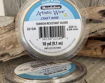 May include: A spool of silver-plated tarnish resistant Artistic Wire, 22 gauge, 10 yards (9.1 meters) in length. The label reads "Beadalon Artistic Wire Craft Wire".