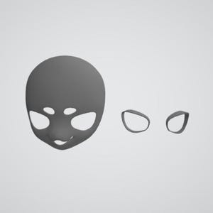 May include: A grey, 3D-printed doll face with cut-out eyes and mouth, and two separate eye shapes. The face is smooth and rounded, with a neutral expression. The eye shapes are simple ovals.