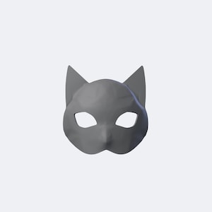 May include: A low-poly style cat mask in a solid matte gray finish. The mask features pointed ears, almond-shaped eye cutouts, and a faceted geometric surface design that creates sharp angles and distinct planes across the entire face.