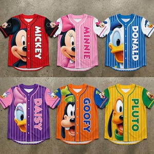 May include: Six baseball-style jerseys featuring Disney characters Mickey, Minnie, Donald, Daisy, Goofy, and Pluto. Each jersey has a character's face on the front and the character's name vertically down the side. The jerseys are red, pink, blue, purple, orange, and yellow.