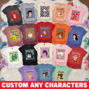 Op de afbeelding: Een verzameling kleurrijke t-shirts met verschillende personages zoals Ariel, Ursula en Flounder. Elk shirt heeft een afbeelding van een personage op een geruite achtergrond. De tekst "CUSTOM ANY CHARACTERS" staat onderaan.