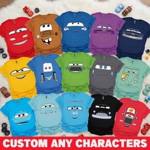 May include: A selection of brightly coloured t-shirts with cartoon car designs. The shirts are in various colours, including red, blue, yellow, and green. The text "CUSTOM ANY CHARACTERS" is displayed at the bottom of the image.