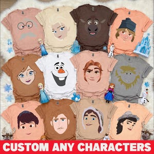 May include: Assorted t-shirts featuring cartoon character faces in various colors. The shirts are displayed on a white fluffy surface. The text "CUSTOM ANY CHARACTERS" is at the bottom of the image.