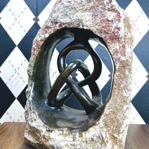 May include: A set of three ceramic mugs with a speckled, matte finish. The mugs are in shades of cream, light gray, and dark gray. Each mug has a simple, minimalist design, perfect for coffee or tea.